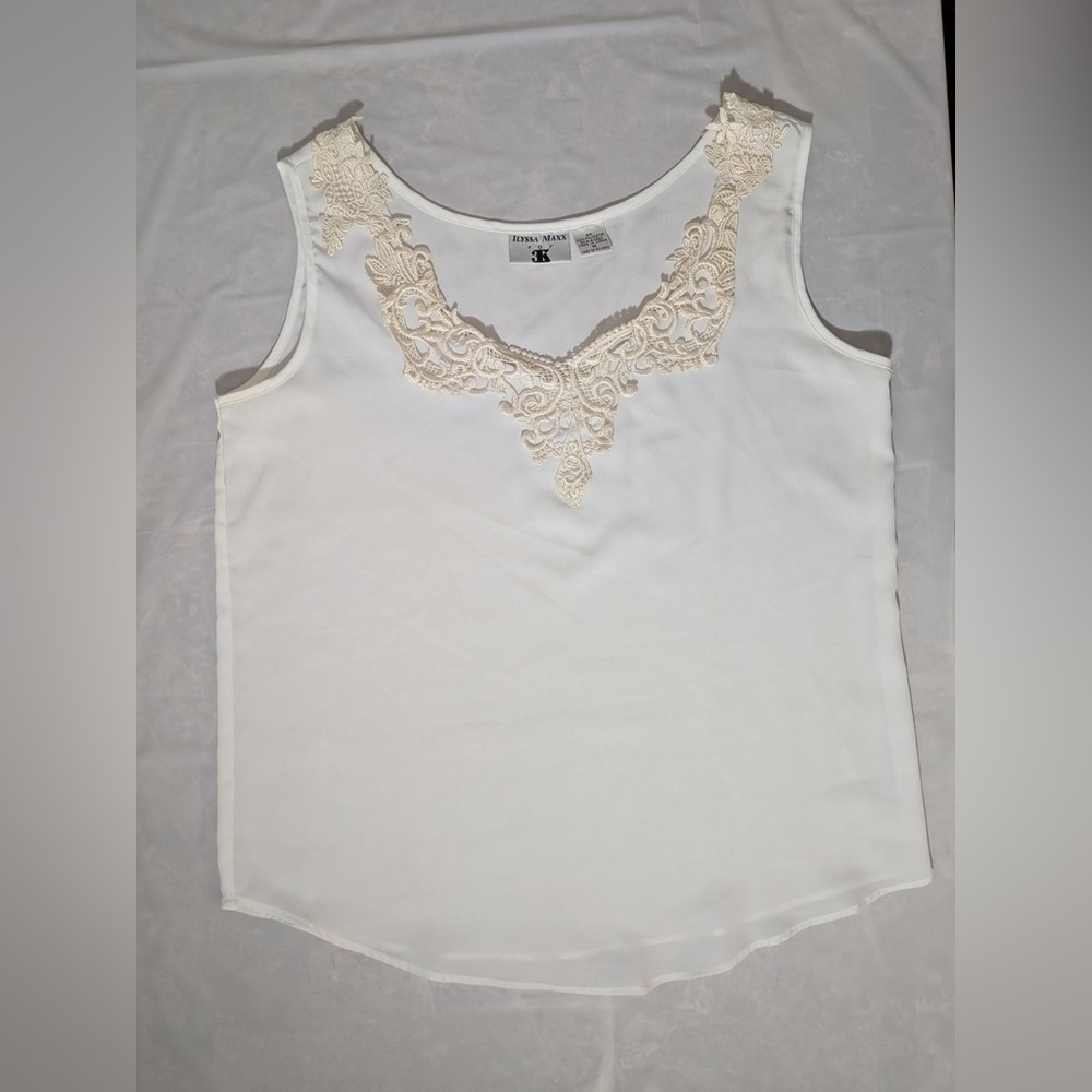 ILYSSA Maxx white sleeveless top with a lace neckline. 100% polyester Size M